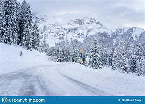 Icy Road In A Majestic Snowy Mountain Scenry On A Winter Day Stock