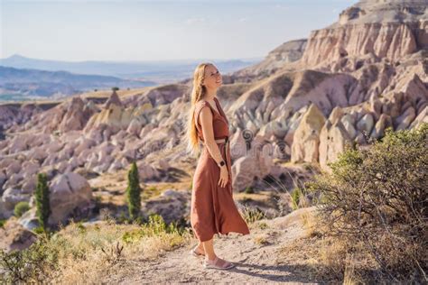 Young Woman Exploring Valley With Rock Formations And Fairy Caves Near