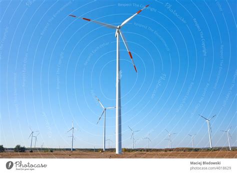 Picture Of A Wind Turbine Farm Against The Blue Sky A Royalty Free
