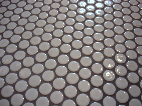 Marble and grey shade penny tiles perfectly fit neutral bathrooms. penny round tiles | Penny round tiles, Penny tiles ...