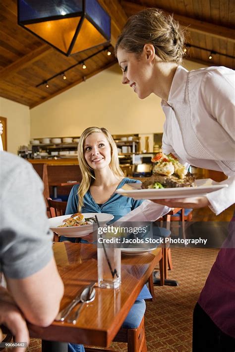 Waitress Serving Food In Restaurant High Res Stock Photo Getty Images