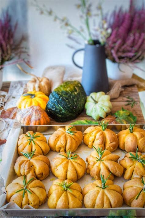 Pumpkins And Gourds Are Arranged On A Table