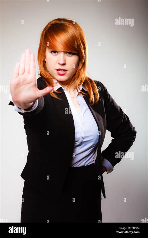 Redhair Businesswoman With Stop Hand Sign Gesture On Gray Business
