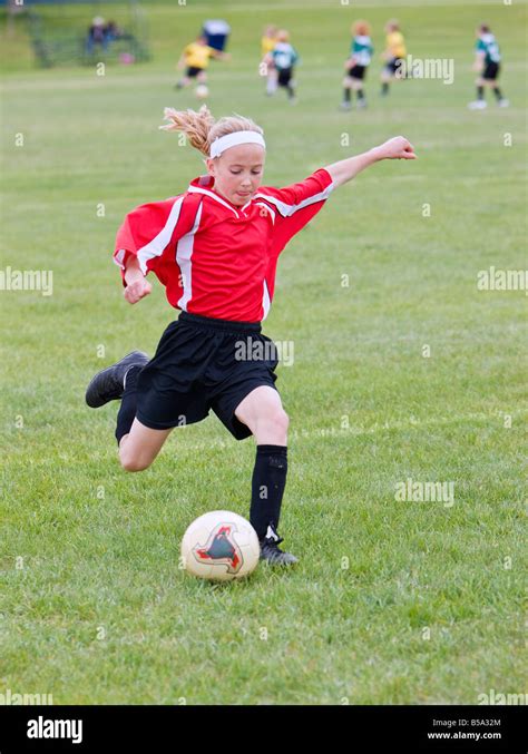 Female Soccer Player Kicking The Ball Stock Photo Alamy