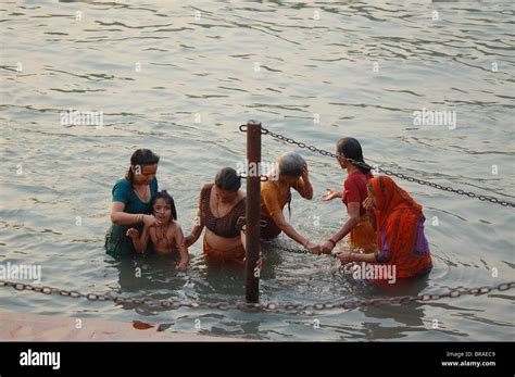 Women Bathing In Holy River Ganges In India During Kumbh Mela Festival