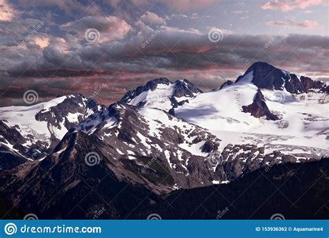 Scenic View Of Snow Covered Mountain Peaks At Sunrise Stock Photo