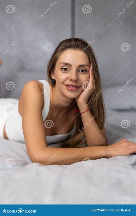 Smiling Brunette Woman Sitting On Bed At Home In Bedroom Stock Image Image Of Bedroom