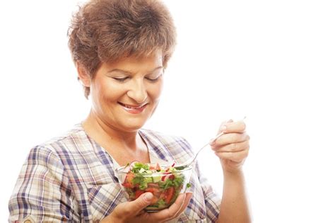 premium photo mature smiling woman eating salad