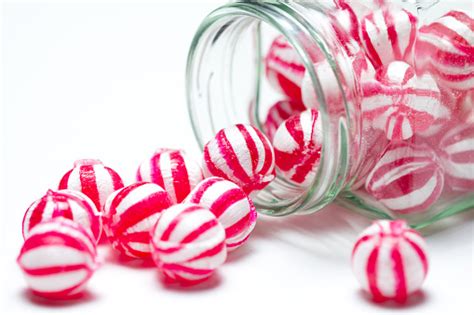 Closeup Photo Of Red And White Striped Candies In A Jar Stock Photo