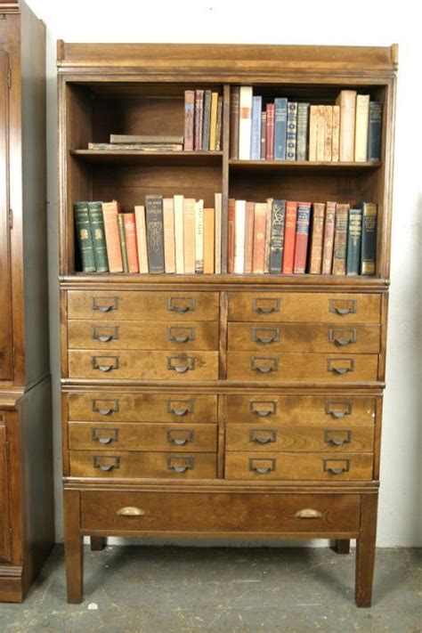 A bookcase, or bookshelf, is a piece of furniture with horizontal shelves, often in a cabinet, used to store books or other printed materials. 4 Stack wooden file cabinet/bookcase
