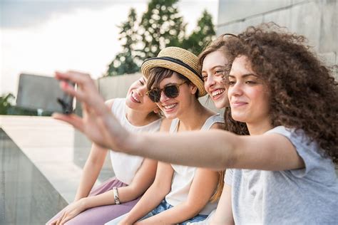 Four Happy Girlfriends Taking A Selfie Spring Season By Stocksy