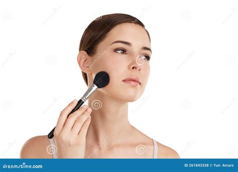 Adding Some Colour A Beautiful Young Woman Applying Blusher Against A