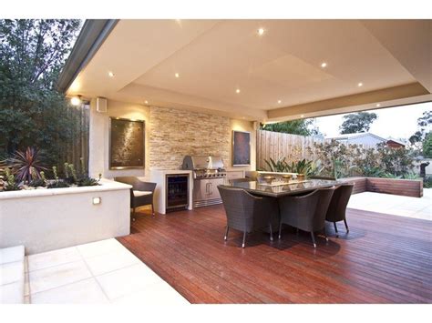 Walled Outdoor Living Design With Bbq Area And Decorative Lighting Using