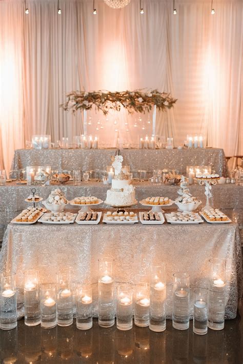 The Cake Table With This Beautiful White Cake Made By Sweet Philosophy And Cupcakes And