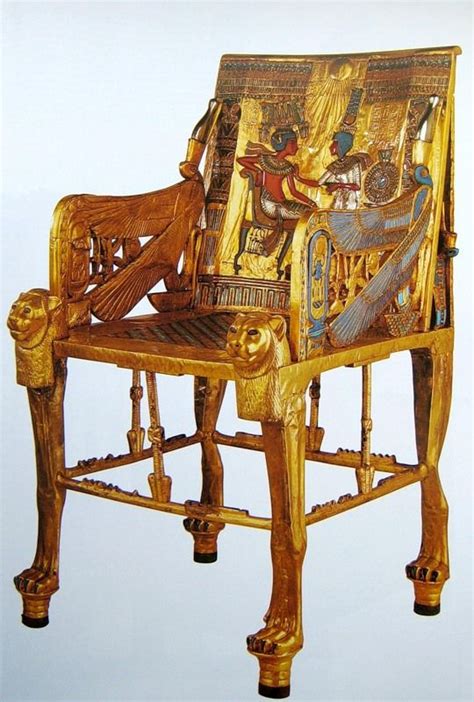 An Ornately Decorated Wooden Chair With Gold Paint On Its Back And Sides