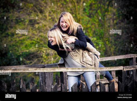 Two Women Having Fun On Bridge Stock Photo Alamy