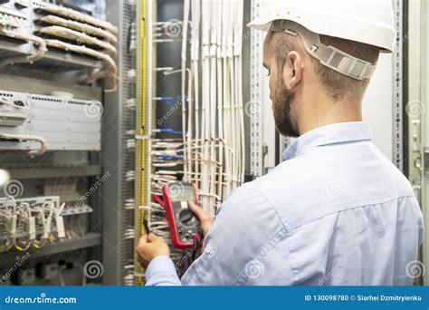 Young Electrician Working On Electric Panel Electrician Engineer Tests