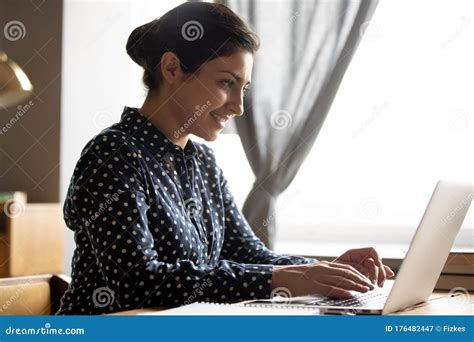 Smiling Indian Woman Working On Laptop Typing On Keyboard Stock Image