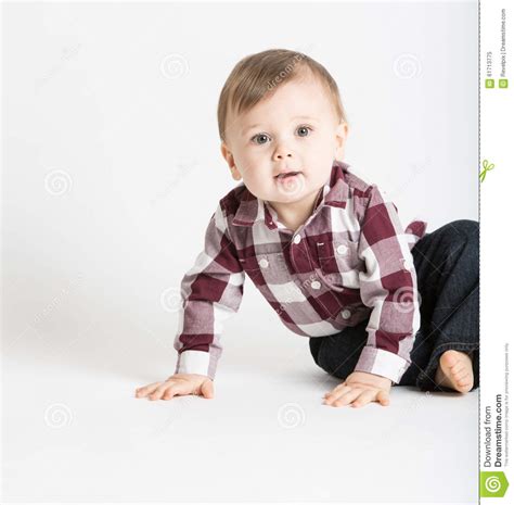 Baby Sitting To The Side In Flannel And Jeans Looking Curious Stock