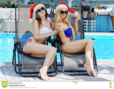 Two Beautiful Girls Red Caps Santa Claus Pool Background Stock Photos