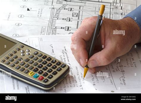 Engineer Doing Hand Calculations On A Calculation Sheet With A