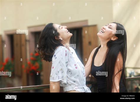 Two Women Standing Outdoors Laughing Stock Photo Alamy