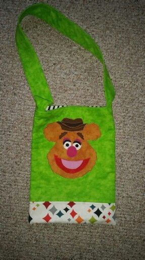 A Green Bag With An Image Of Sesame The Bear On Its Front Pocket