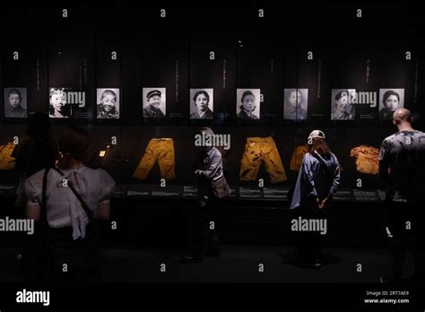 Visitors take a look at the photographs depicting the aftermath of the