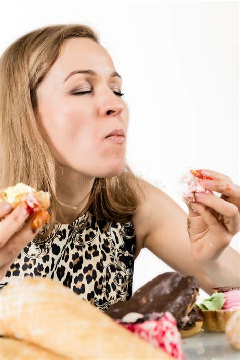 Young Woman Eating Cupcakes With Pleasure After A Diet Stock Image