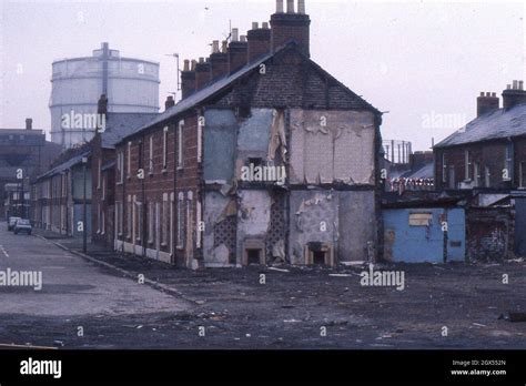 Terrace houses in Salisbury Street, Belfast, half-demolished, against a