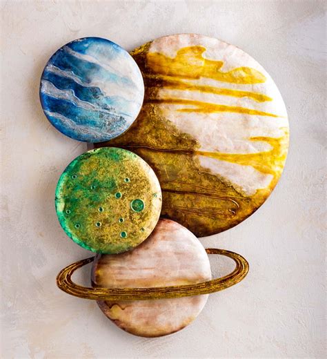 bring the universe down to earth when you display this colorful metal and capiz planets wall art