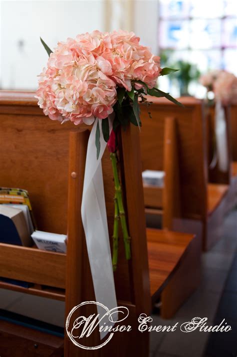 Coral Hydrangea Pew Arrangements Down The Church Aisle For The Ceremony