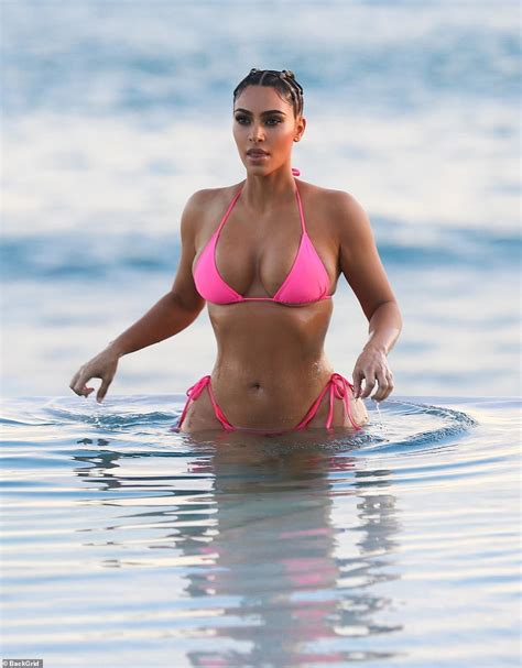 kim kardashian flaunts her enviable figure in vibrant pink swimwear during sizzling photoshoot