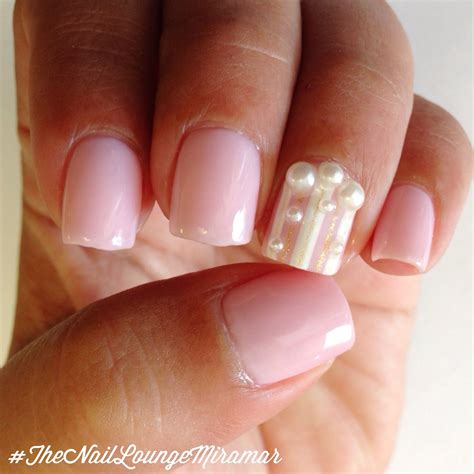 A Womans Hand With Some Pink And White Nail Polishes On Her Nails