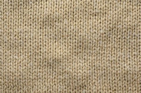 Knit Texture Of Beige Wool Knitted Fabric With Regular Pattern Knit