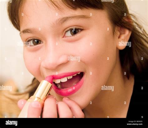 Preteen Girl Putting On Lipstick Stock Photo Alamy