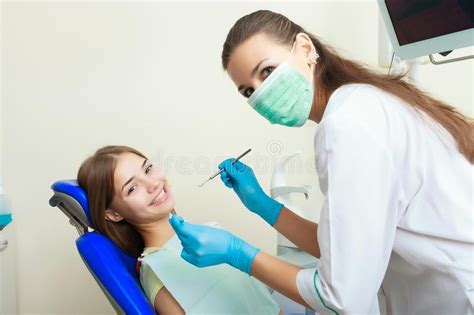 Beautiful Woman Patient Having Dental Treatment At Dentist S Office