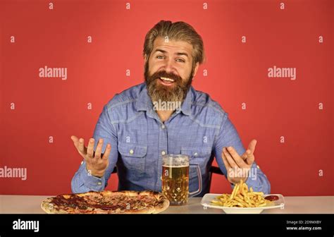 Man Watching Football While Drinking Beer With Pizza And French Fries Eating Pizza And Drink