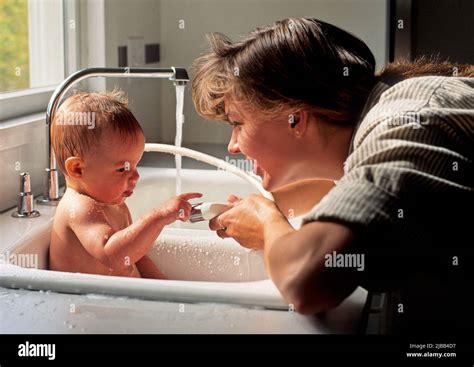 Mother Bathing Her Baby Stock Photo Alamy