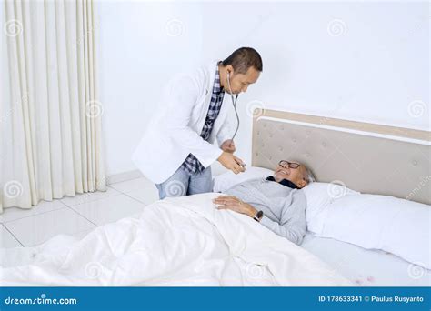 Male Doctor Checking His Patient With Stethoscope Stock Image Image