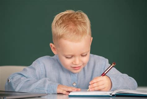 Premium Photo Child At School Kid Writing In Notebook In Class Kid Is