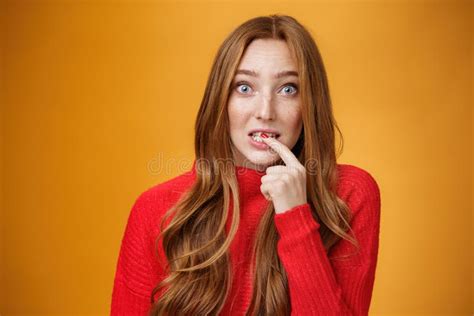 Silly Cute Redhead Woman Making Innocent Oops Expression Holding Finger On Lip And Looking