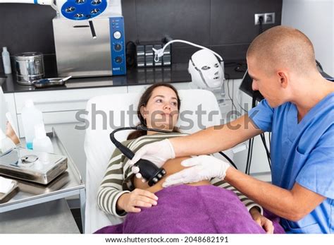 Professional Male Beautician Performing Rf Lifting Stock Photo