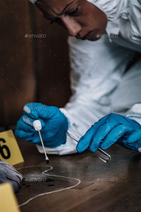 Forensics Collecting Clues From The Crime Scene Stock Photo By Microgen