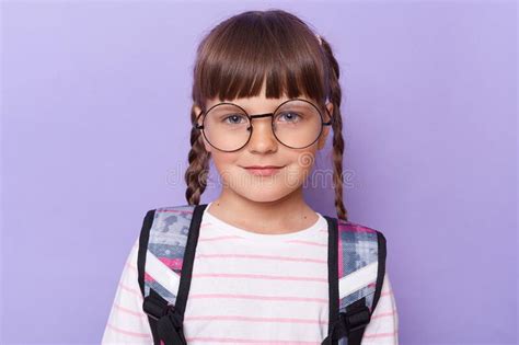 Portrait Of Cute Charming Schoolgirl In Glasses Wearing Backpack