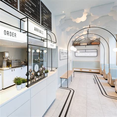 The Interior Of A Restaurant With White Walls And Black Trim On The