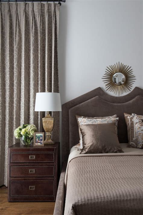 Create a bedroom you never want to leave. Taupe Transitional Bedroom With Metal Starburst Mirror | HGTV