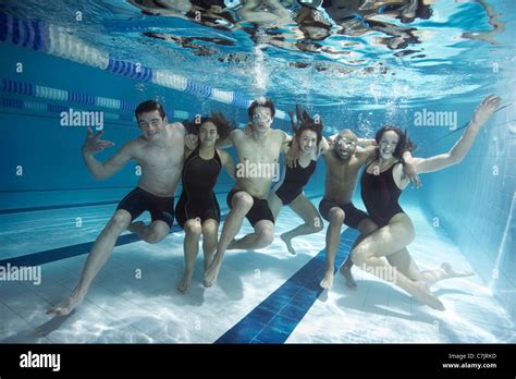 Swimmers Posing Underwater Together Stock Photo Alamy