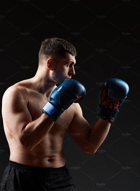 Low Key Studio Portrait Of Handsome Muscular Fighter Practicing Boxing