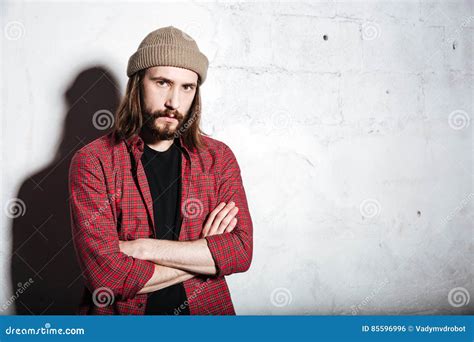 Concentrated Hipster Man Wearing Hat Looking At Camera Stock Photo